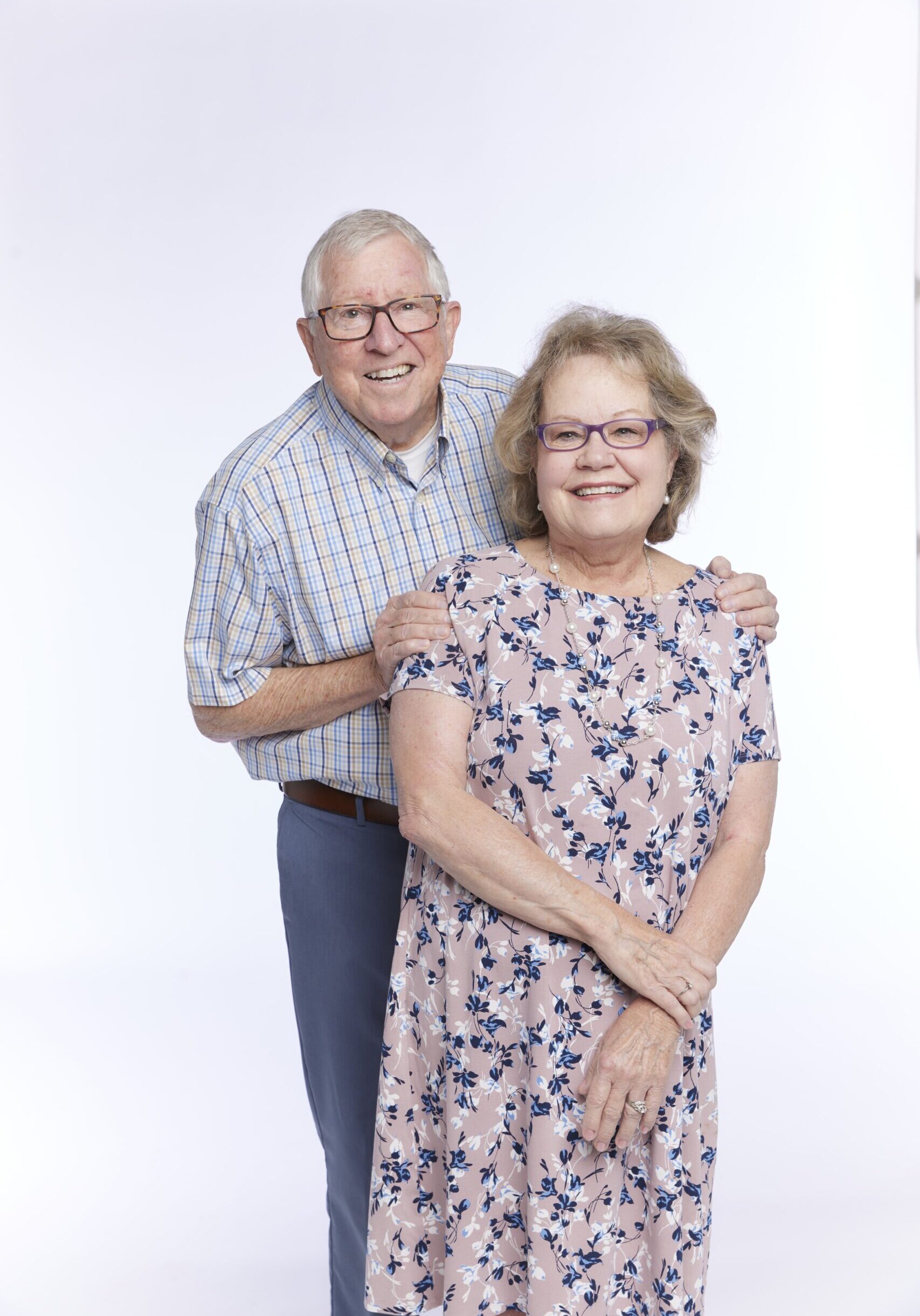 60+ aged couple smiling and hugging