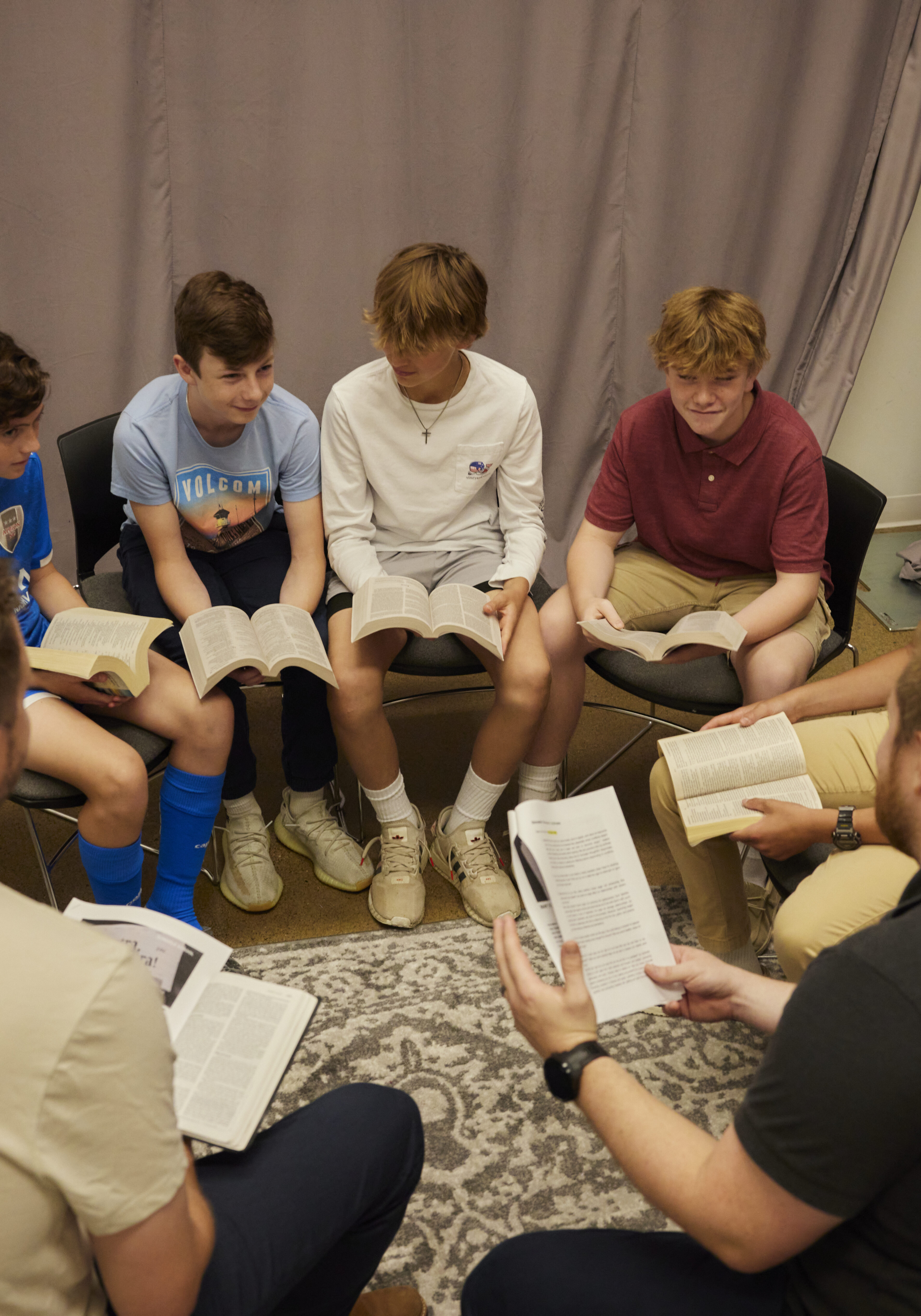 RHCC children sitting in a circle reading the Bible