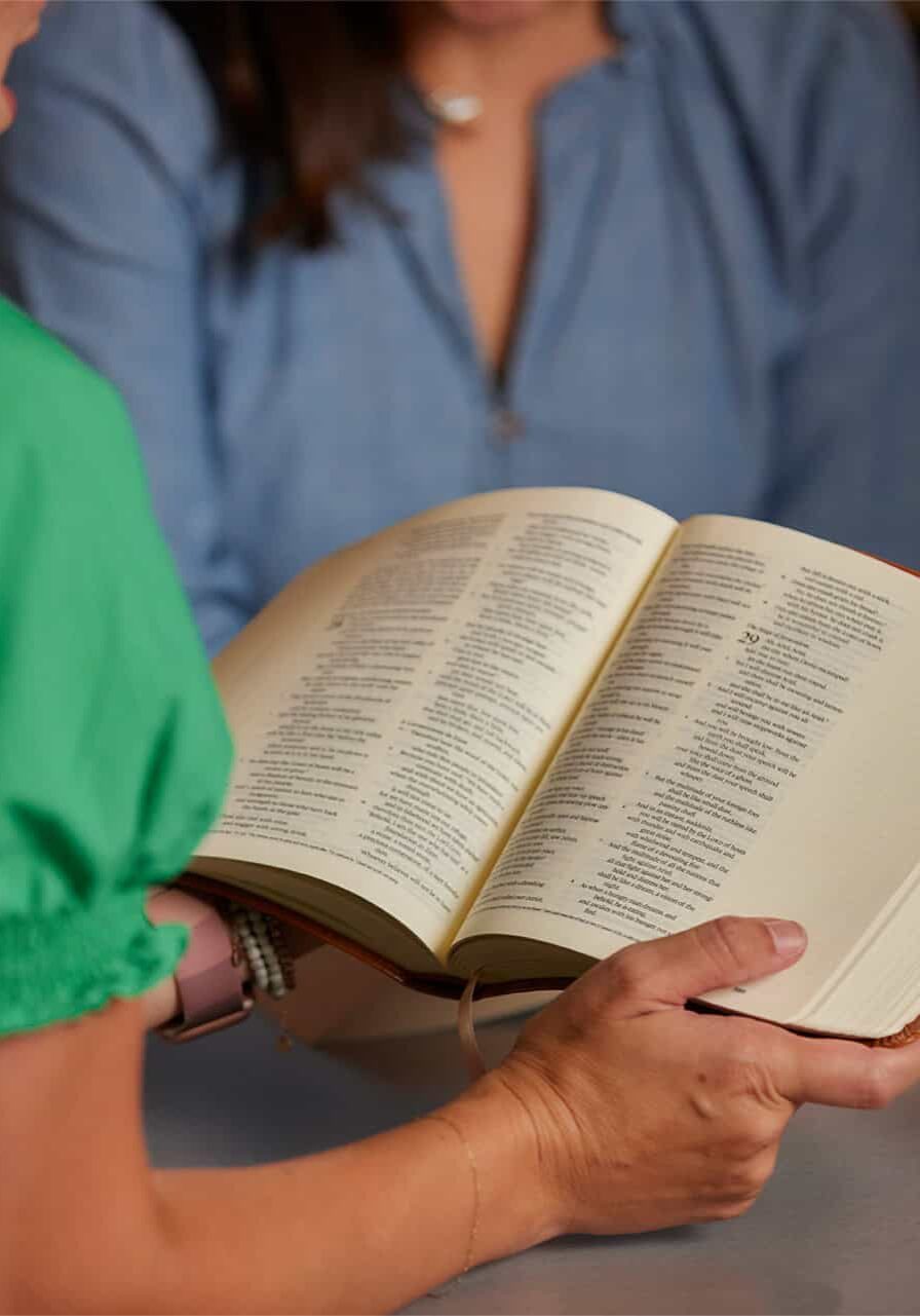 woman reading bible in a ministry community at RHCC