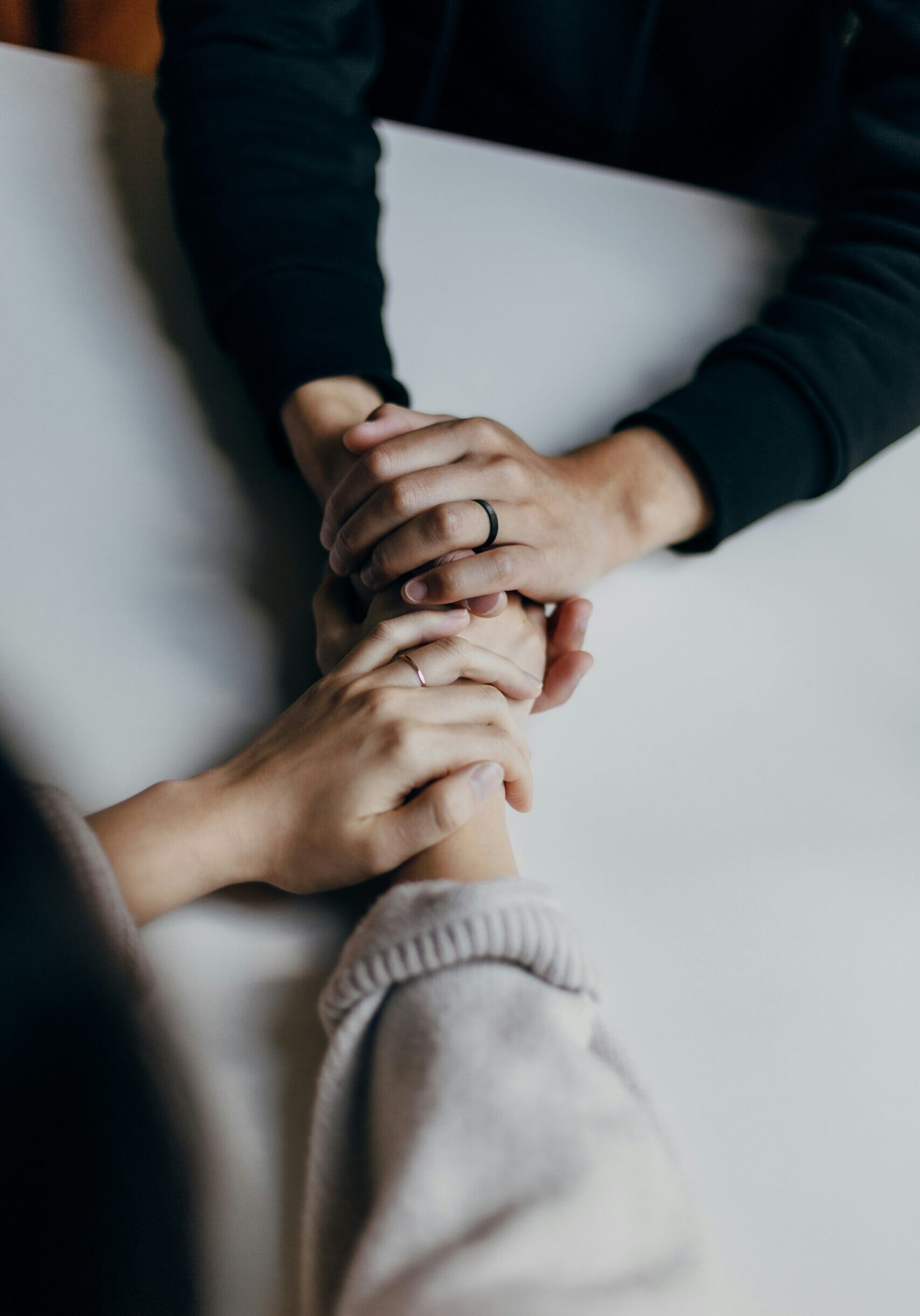 four people holding hands in prayer during RHCC Care Ministry